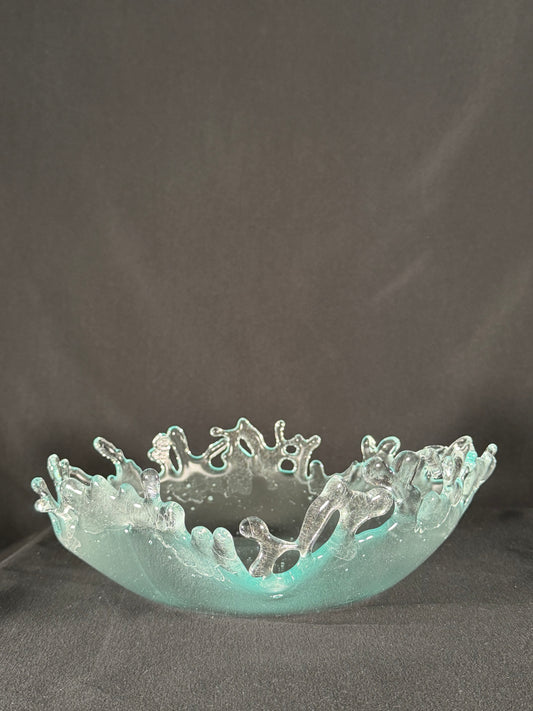 Decorative glass piece with intricate design on a dark background