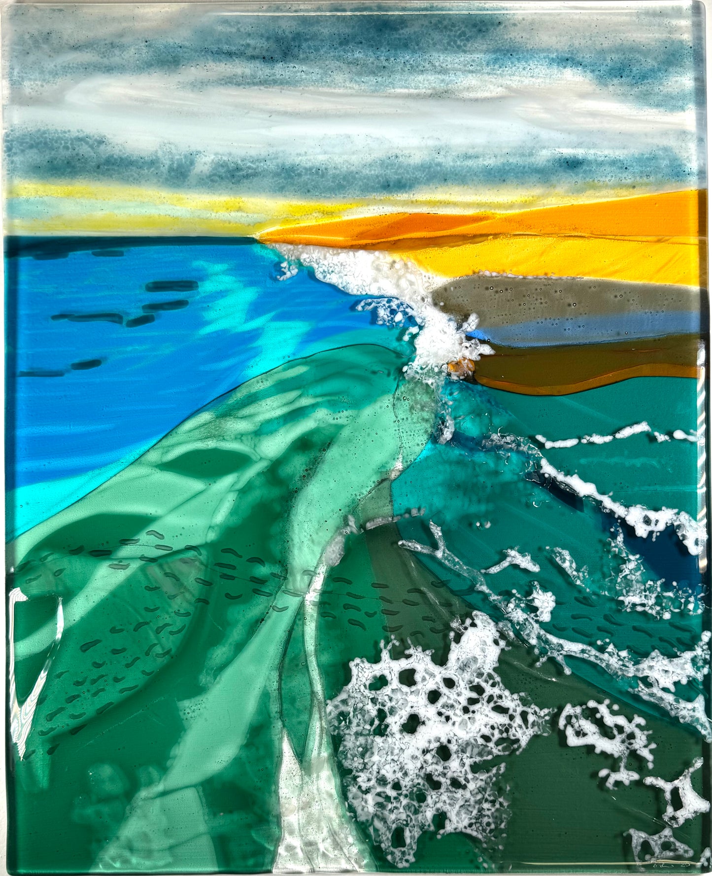 Artistic depiction in glass of a wave crashing onto a beach with blue water and yellow sky.