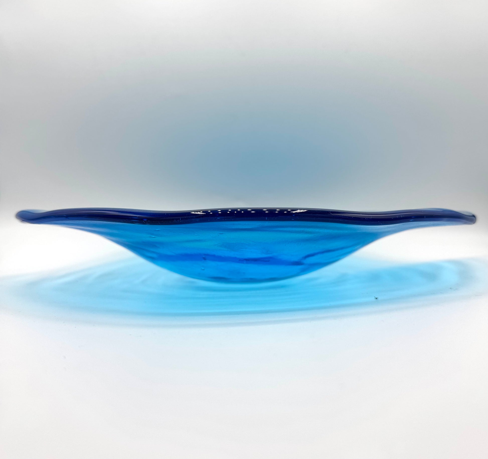Blue glass bowl on a white background