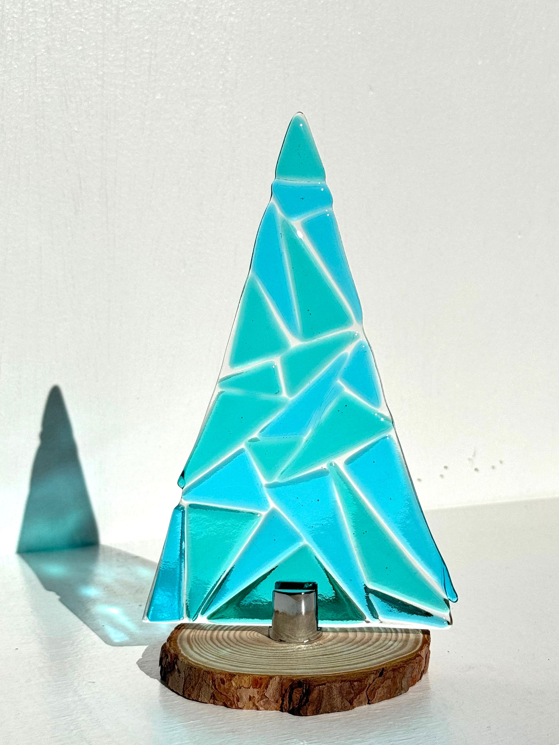 Carribean sky table top Christmas Tree is made up of Blue Sky glass and Carribean green. This tree was created with texture you can feel. Can be easily removed from wood base. 