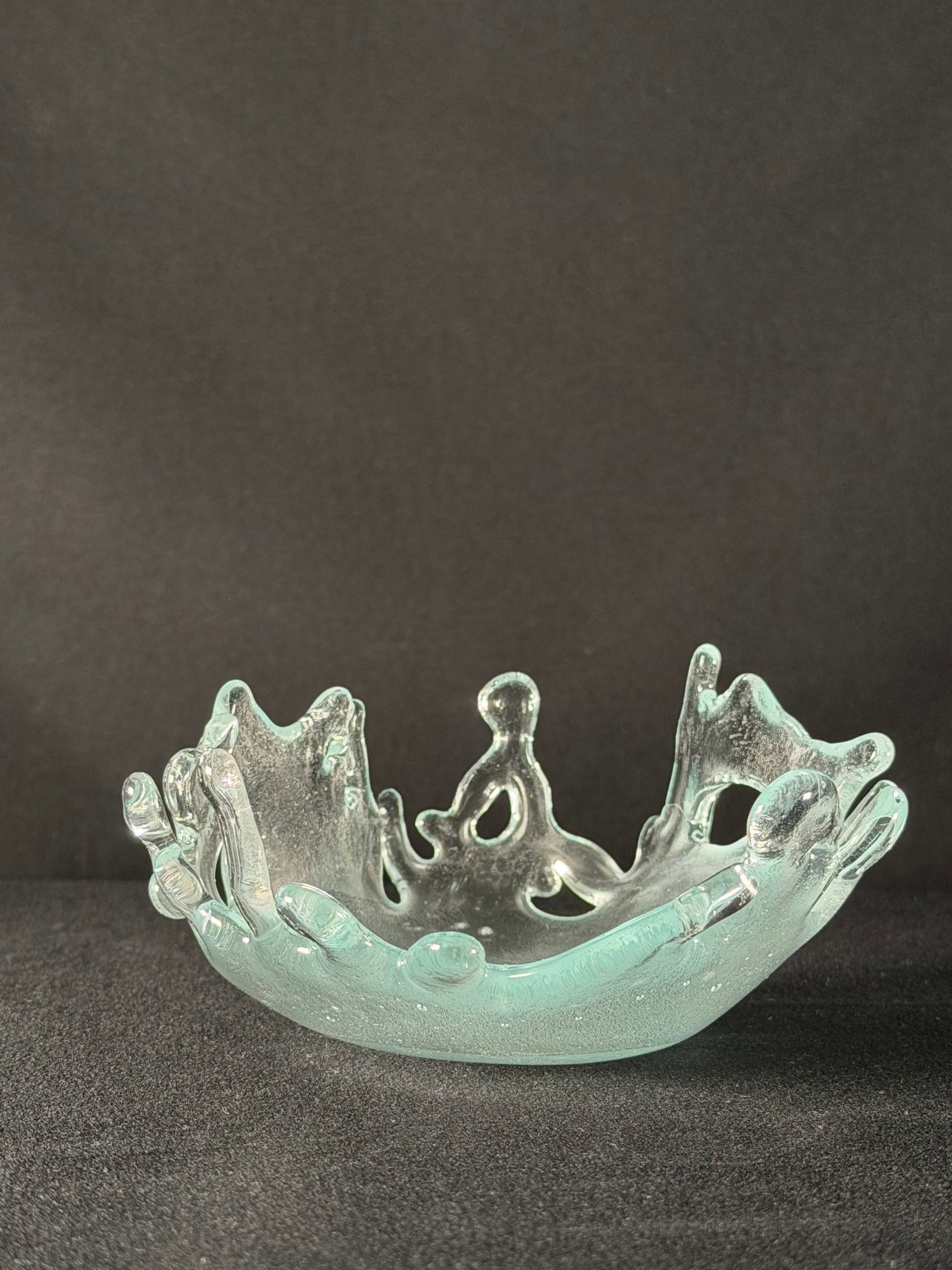 Clear glass splash on a dark background