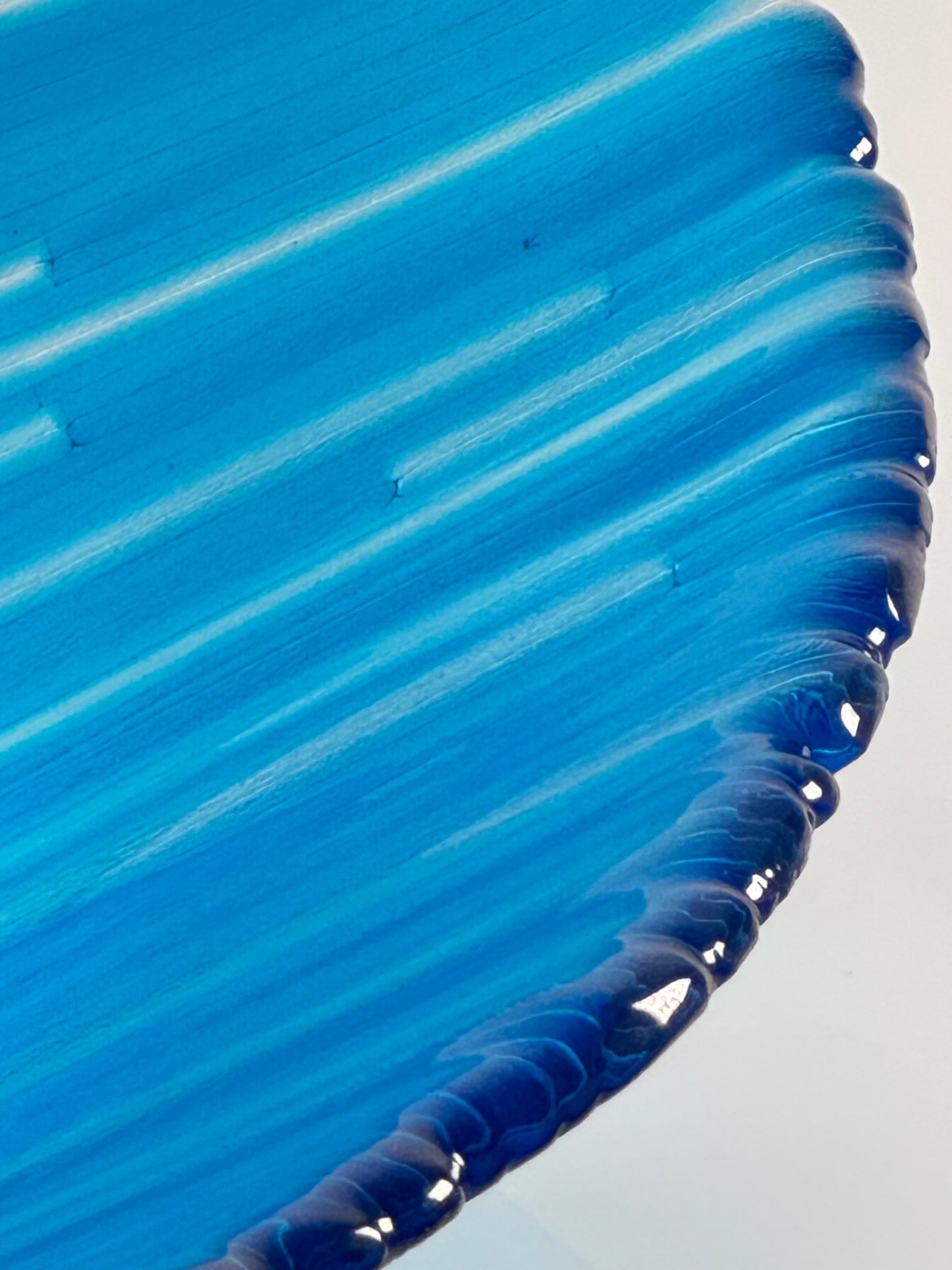 Close up of a glass bowl made of blue and clear glass