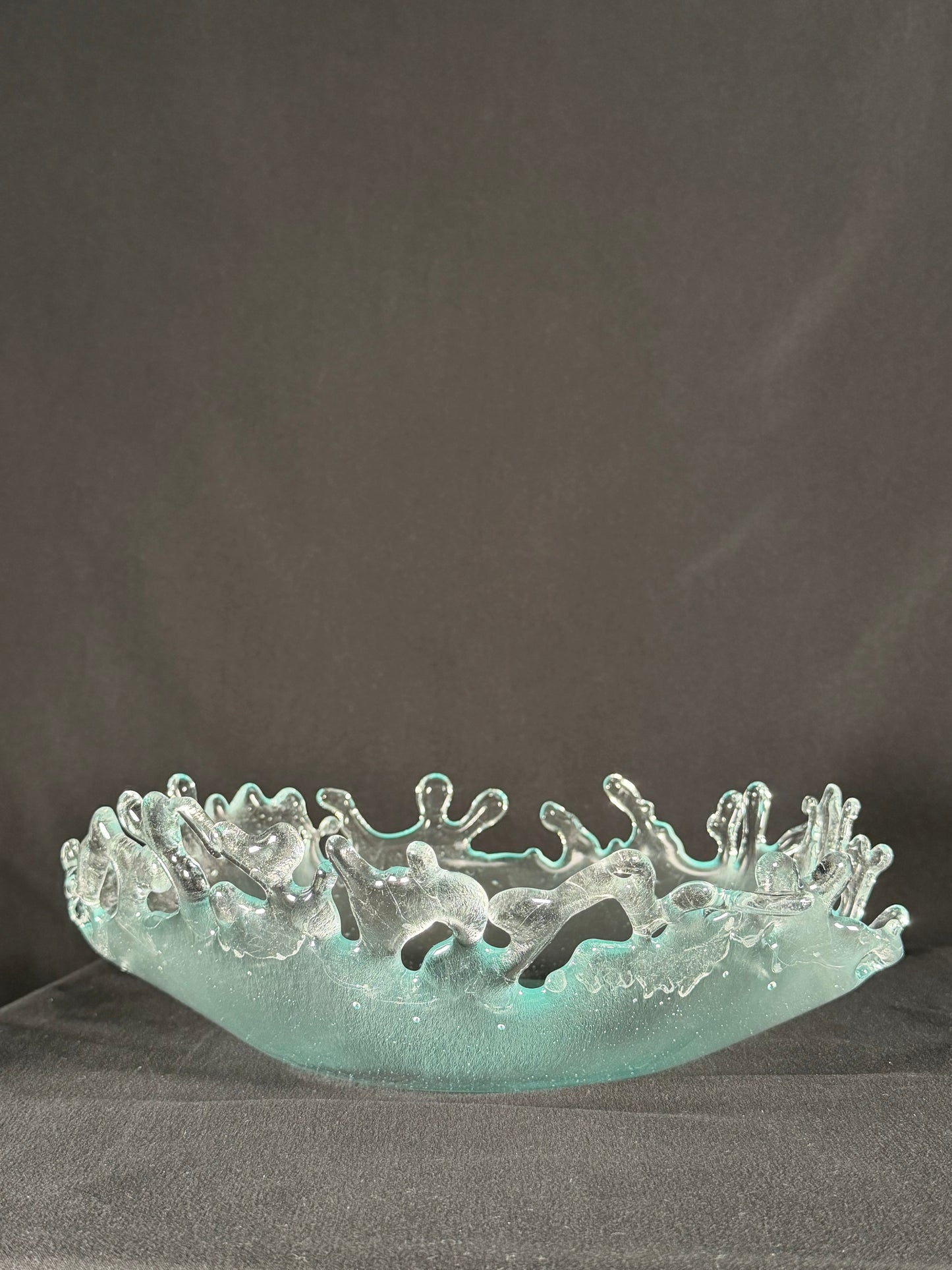 Glass bowl with tangible splashes erupting from the surface
