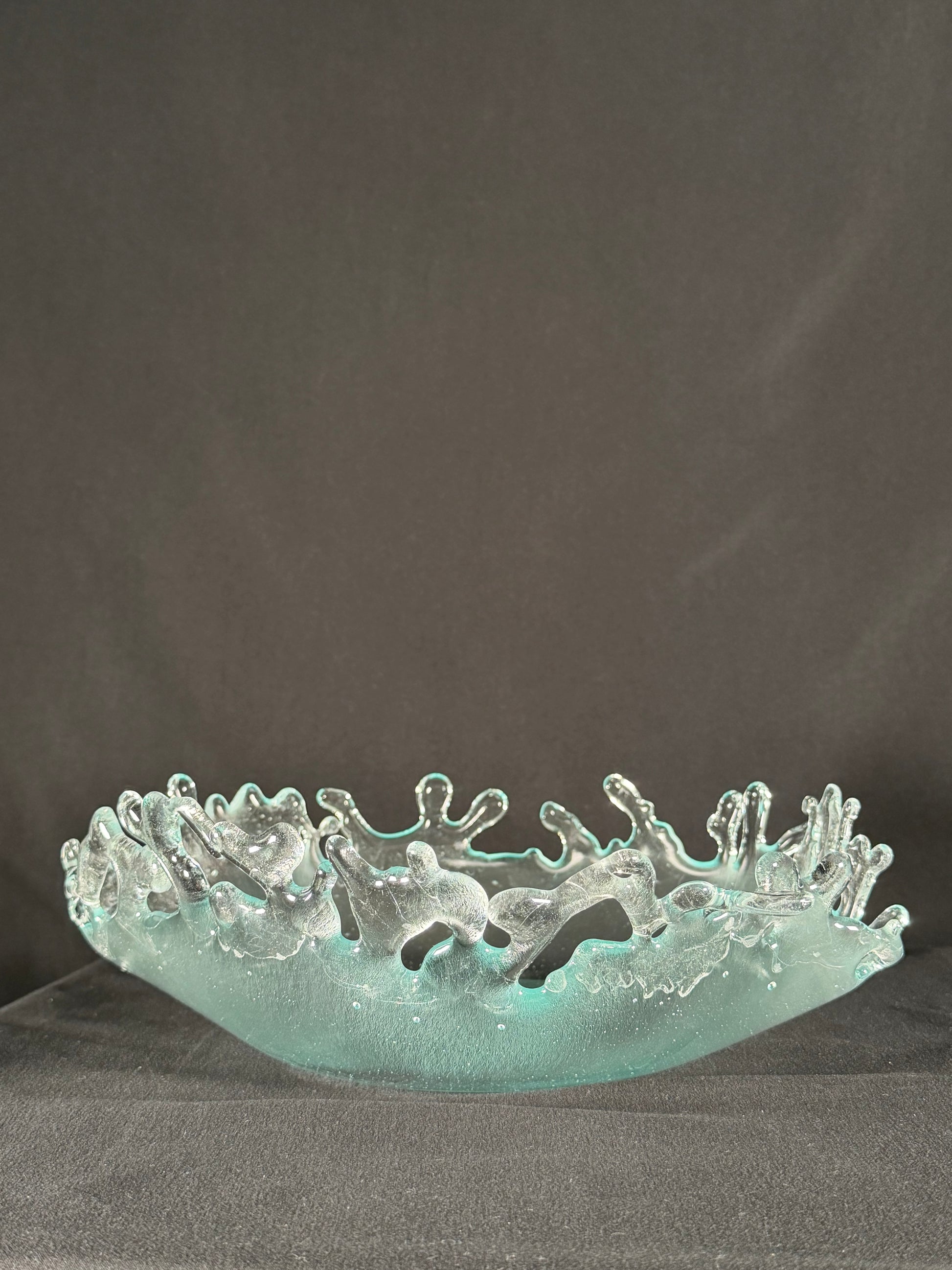 Glass bowl with tangible splashes erupting from the surface