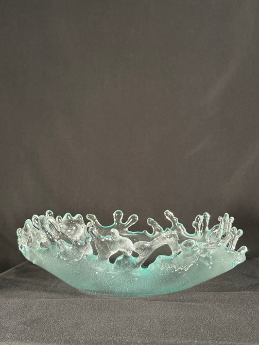 Glass bowl with tangible splashes erupting from the surface