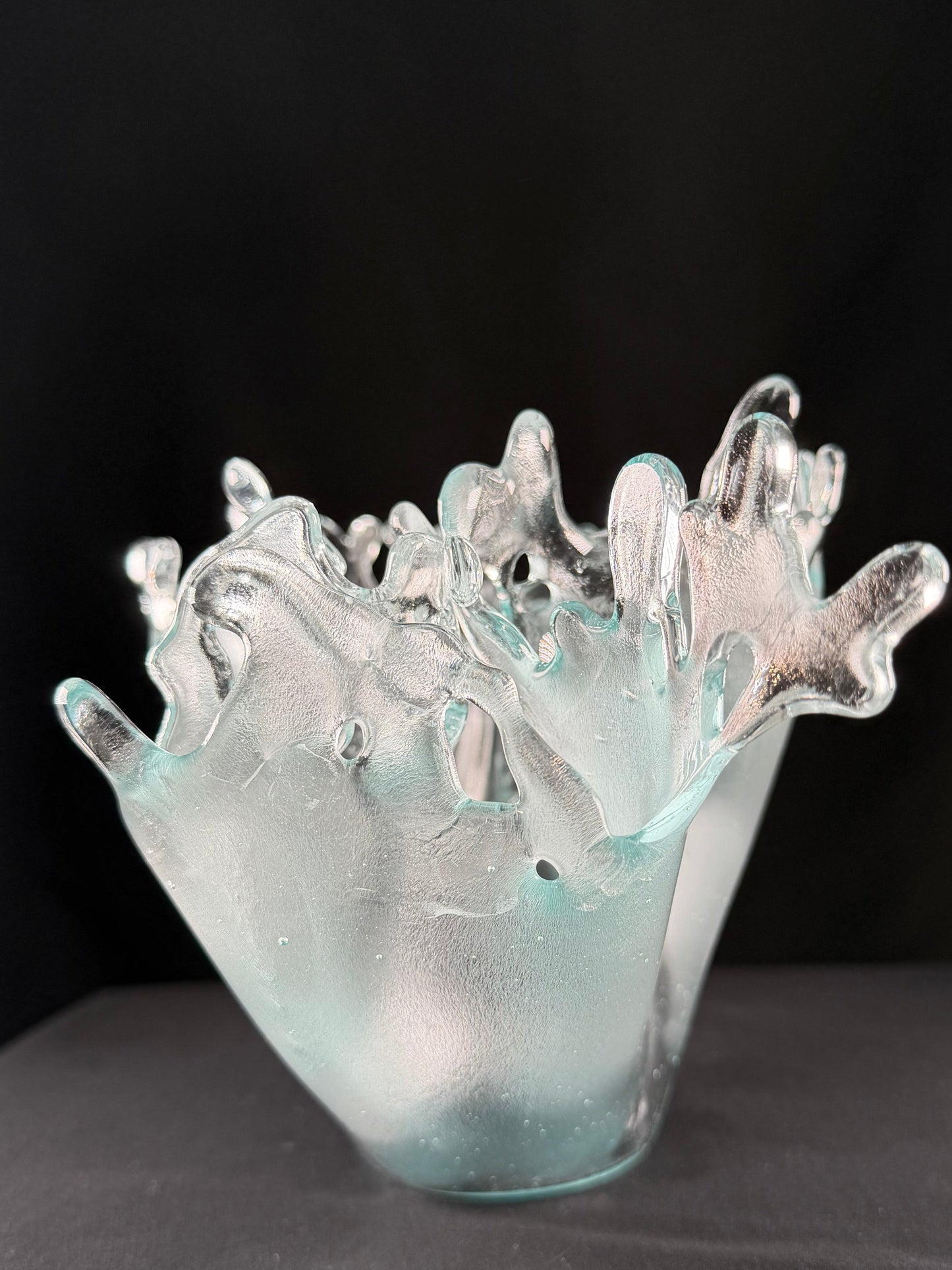 Clear glass sculpture of splashing water