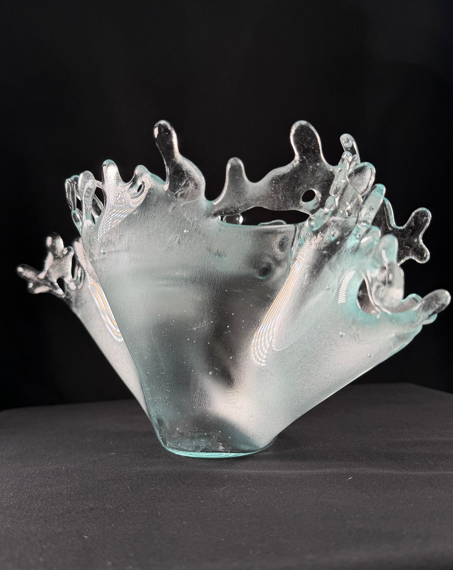 Glass bowl with wave-like design on a black background
