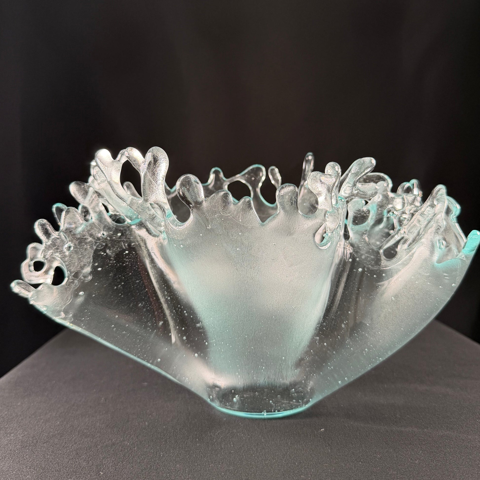 Glass sculpture with intricate design on a black background