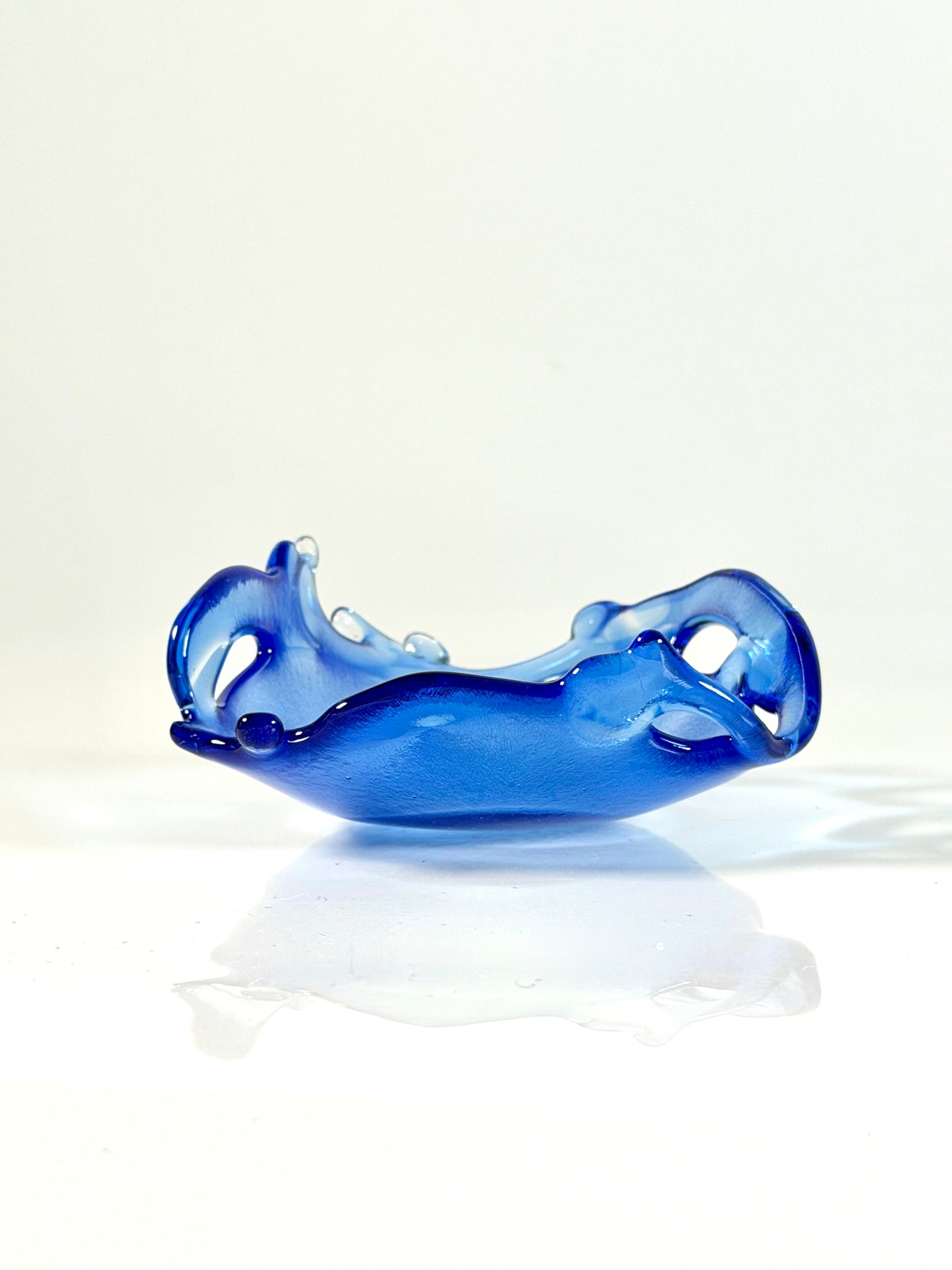 Blue glass bowl on a white background