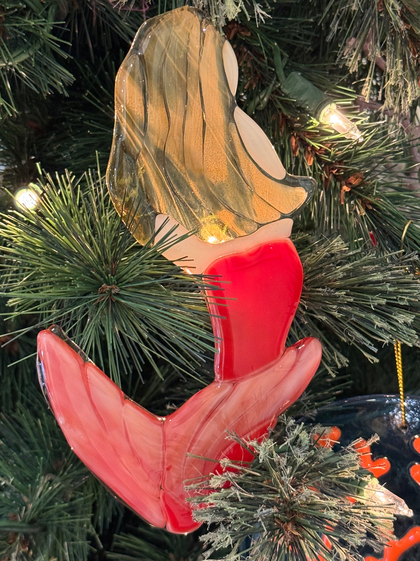 Mermaid suncatcher or ornament hung in a Christmas tree
