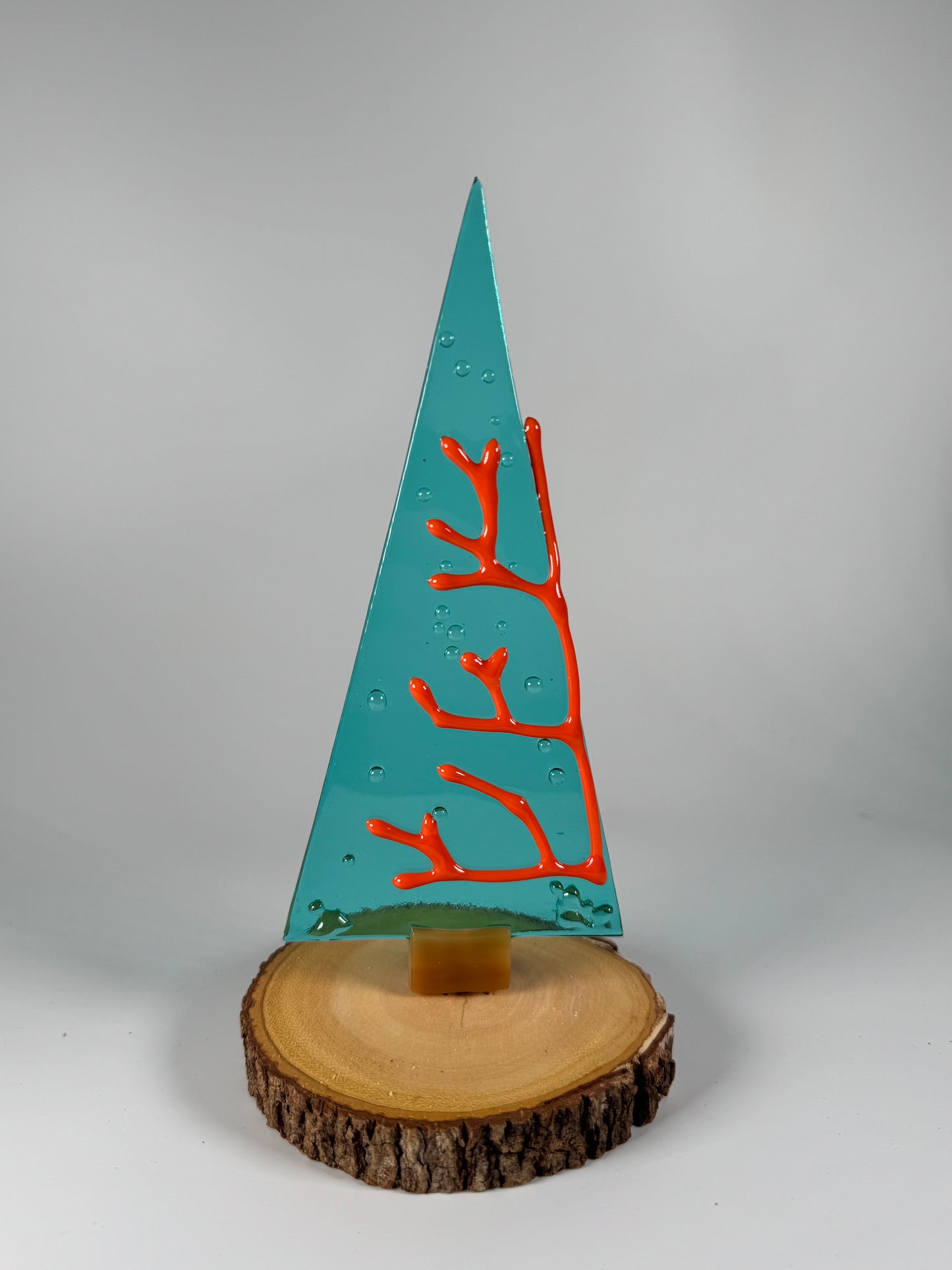 Glass Tree in wood stand. Textured red coral and bubbles you can feel on light gray background 