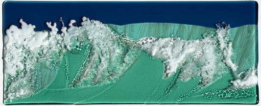 Seaside fused glass art panel showing waves crashing. Created with sea green, dark blue and white.