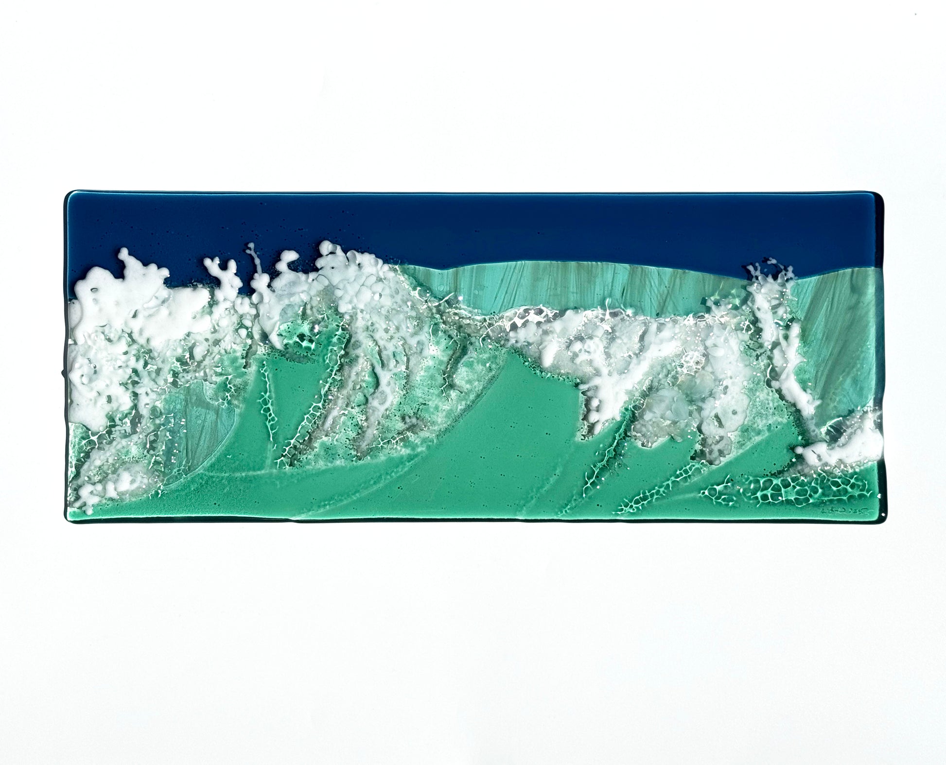 Seaside art panel shown depicts the waves of the ocean crashing. Multiple layers creating texture you can feel. Seaside is shown flat on a white table to allow you to see the work clearly  before it is hung. 