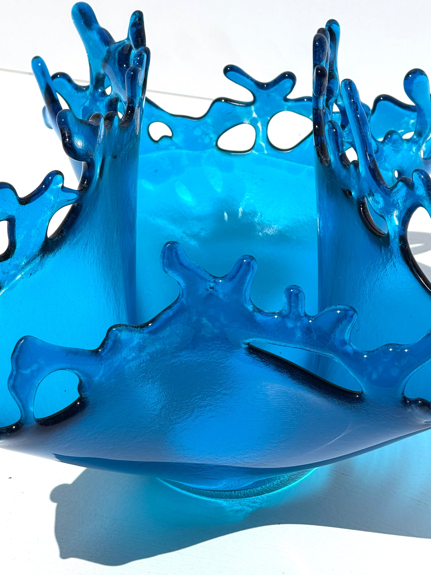 Blue transparent sculpture on a white background