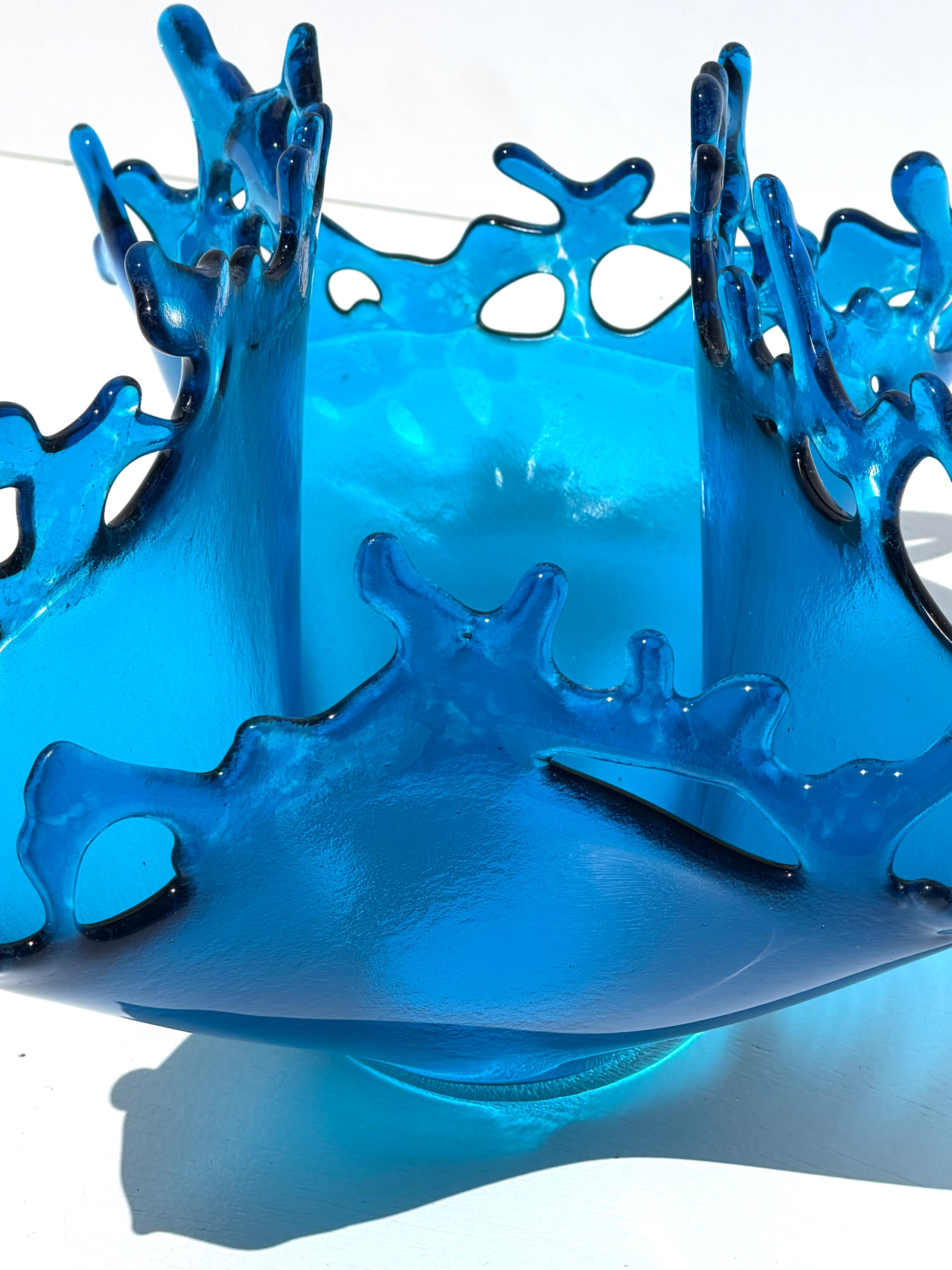 Blue transparent sculpture on a white background