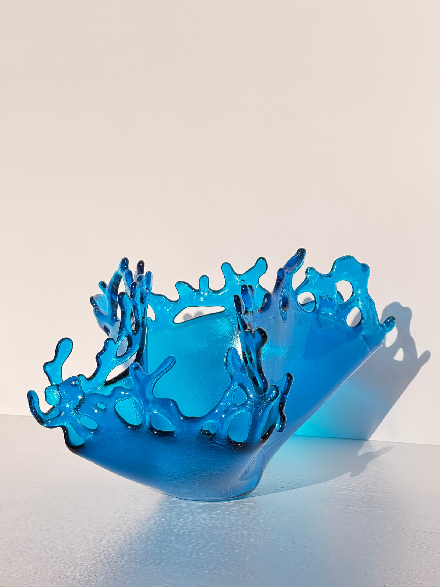 Blue glass sculpture resembling a splash