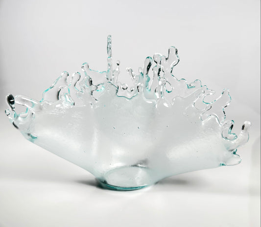Clear glass bowl with wavy edge design on a white background