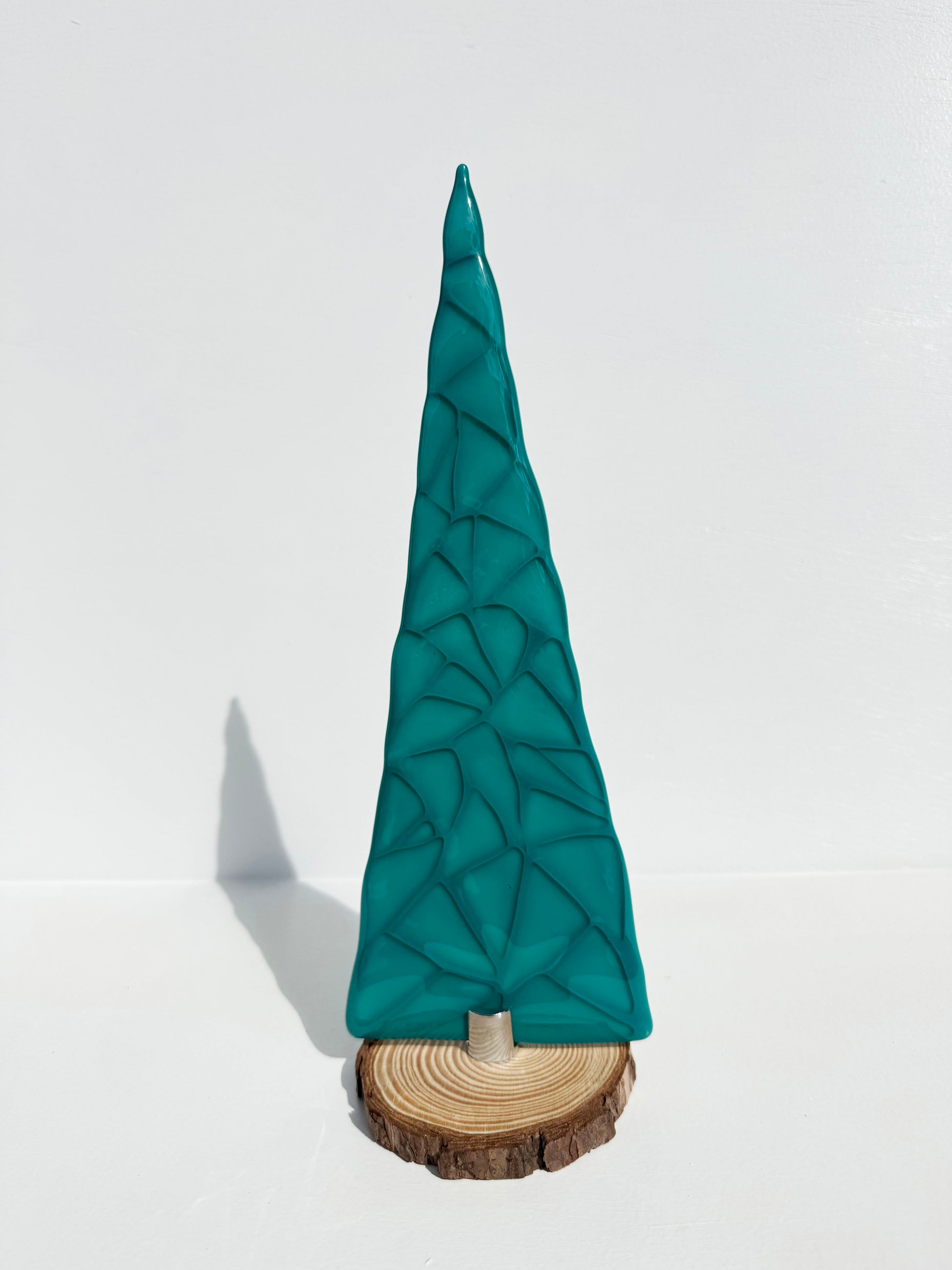 Tall table top tree created with Peacock green and clear glass layered to create depth. 