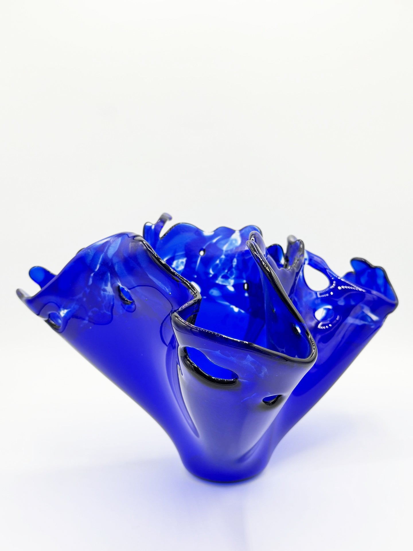 Blue glass vase with a unique design on a white background