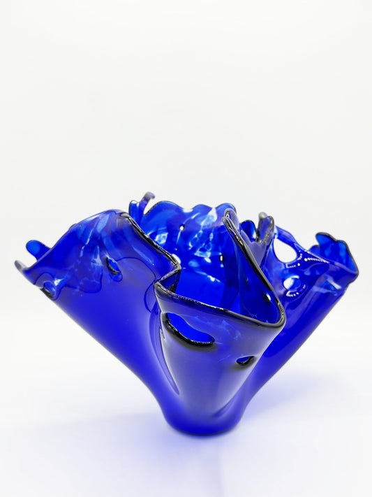 Blue glass vase with a unique design on a white background